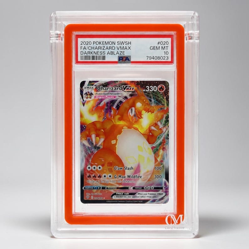 May include: A graded Pok&eacute;mon trading card featuring Charizard VMAX from the Darkness Ablaze set. The card is encased in a clear plastic holder with an orange border. The card's artwork depicts a fiery orange Charizard.