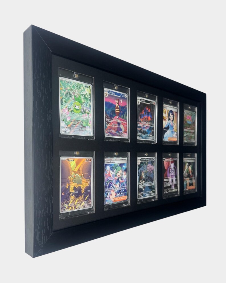 May include: A black framed display case holding twelve trading cards. Each card is encased in a clear protective sleeve. The cards feature colorful illustrations of various characters and scenes.