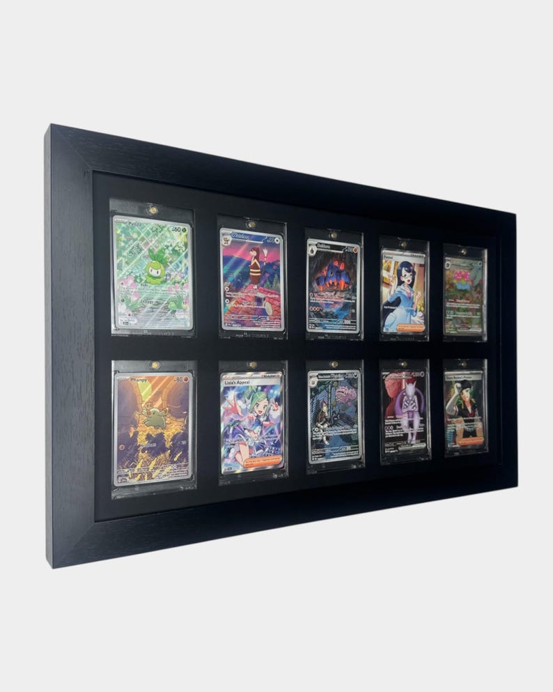 May include: A black framed display case holding twelve collectible trading cards. Each card is encased in a clear protective sleeve. The cards feature colorful illustrations and designs, showcasing a variety of characters and scenes.