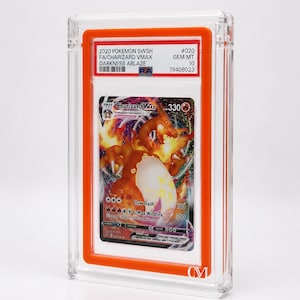 May include: A graded Pok&eacute;mon card featuring Charizard VMAX from the Darkness Ablaze set. The card is encased in a clear, protective holder with an orange border. The card's details include the text "2020 POKEMON SWSH FA/CHARIZARD VMAX DARKNESS ABLAZE" and "GEM MT 10".