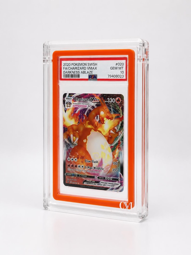 May include: A graded Pok&eacute;mon card featuring Charizard VMAX from the Darkness Ablaze set. The card is encased in a clear, protective holder with an orange border. The card's details include the text "2020 POKEMON SWSH FA/CHARIZARD VMAX DARKNESS ABLAZE" and "GEM MT 10".