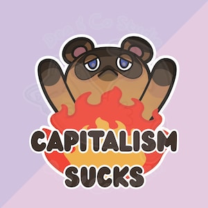 May include: A sticker featuring a cartoon raccoon with a sad expression, surrounded by flames. The text "CAPITALISM SUCKS" is written in bold, white letters. The sticker has a white border and a purple background.