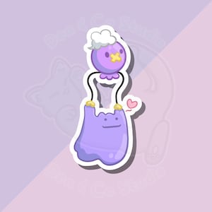 May include: A sticker featuring a purple cartoon character holding another purple character with a white cloud-like top. The top character has a yellow cross on its face. A small pink heart is next to the bottom character.
