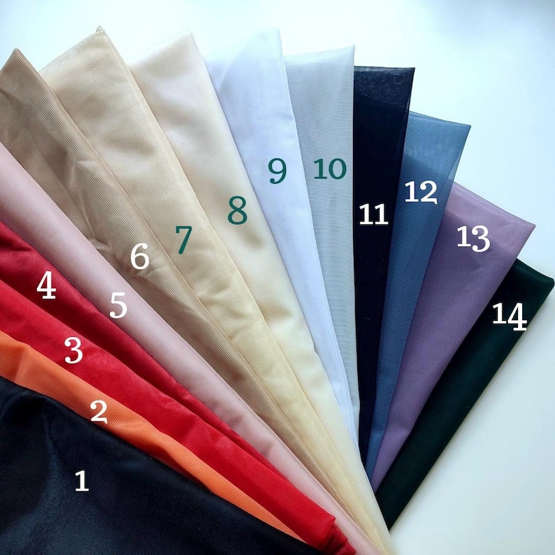 May include: A fan-shaped display of fourteen sheer fabric swatches in various colours, including black, orange, red, pink, beige, cream, white, grey, navy, blue, purple, and dark green, each labelled with a corresponding number from 1 to 14.