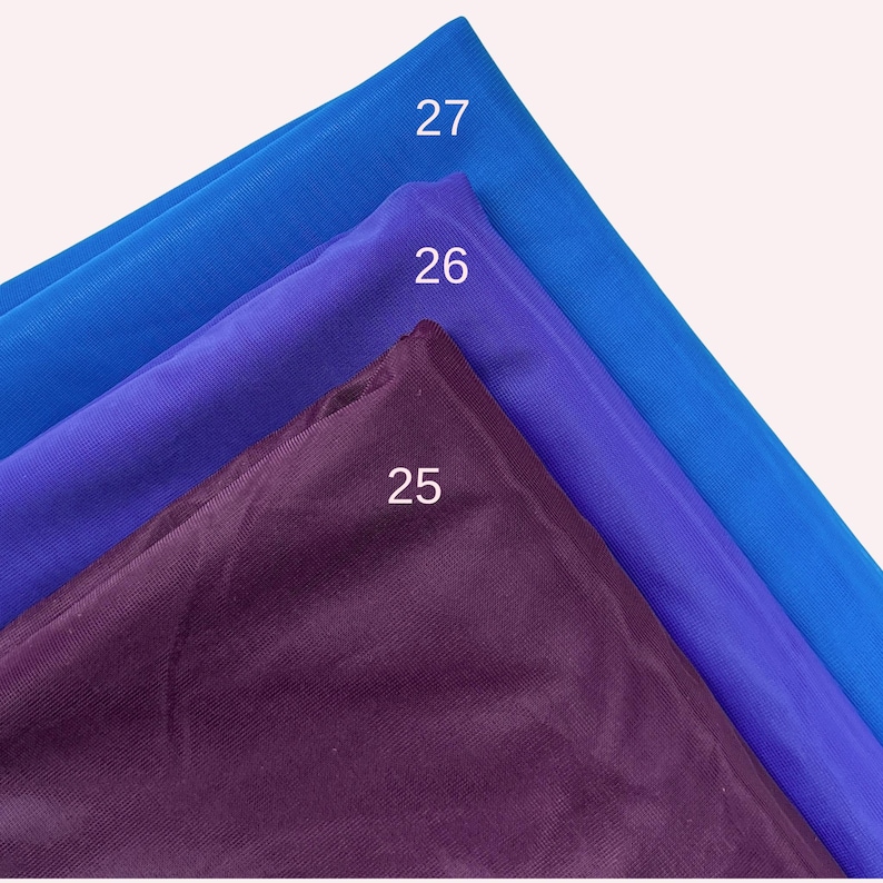 May include: Three layers of semi-sheer fabric stacked diagonally. The top layer is bright blue labelled 27, the middle layer is vibrant purple labelled 26, and the bottom layer is a deep dark plum colour labelled 25. The fabric has a fine mesh texture.