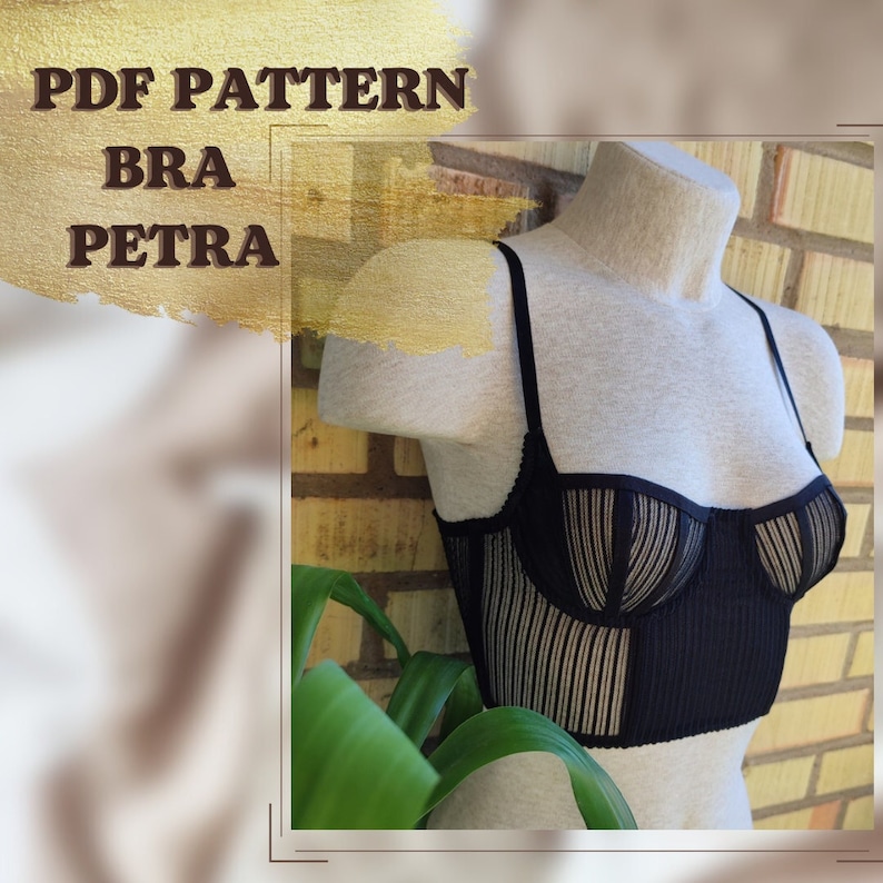 May include: A black bra with a striped pattern on the cups and a solid black band. The bra is on a white mannequin and is displayed against a brick wall.