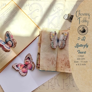 May include: Three paper butterflies with intricate designs and colors, including pink, blue, and yellow, are displayed on top of open books. The butterflies are 3D and appear to be part of a craft project. The text "Charming Fabby" and "3-D Butterfly Insert" is visible in the image.