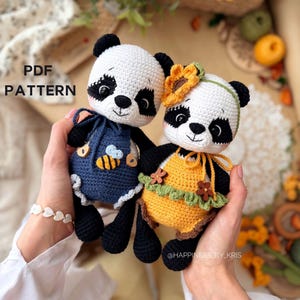 May include: Two handmade crochet panda bears. One panda wears a blue outfit with a bee applique, the other wears a yellow dress with a sunflower headband. The pandas have black and white faces and are held in hands. The text "PDF PATTERN" is visible.
