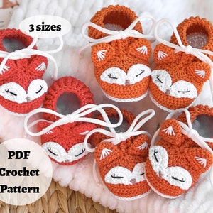May include: Crochet pattern for fox baby booties in three sizes. The booties are orange and red with white accents and laces. The pattern is available as a PDF download.