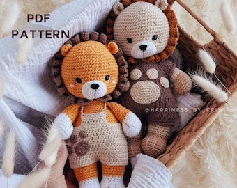 May include: Two crocheted lion plushies in a wicker basket. The lion on the left is wearing overalls and has a brown and orange color scheme. The lion on the right is wearing a brown shirt and has a brown and beige color scheme. The text "PDF PATTERN" is in the top left corner of the image.