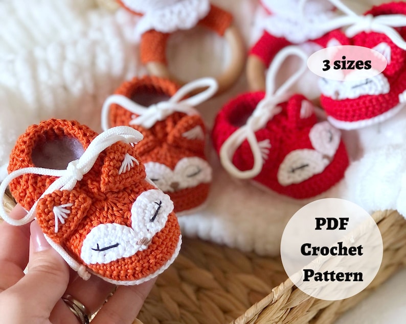 May include: Crochet pattern for a pair of orange fox baby booties with white accents. The pattern is available in three sizes and is a PDF download.