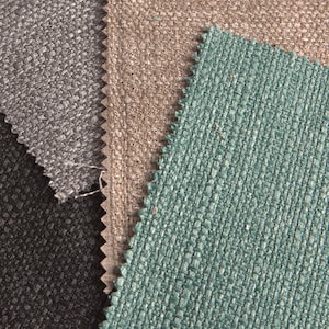 May include: Close-up of four fabric swatches in different colors and textures. The swatches are black, gray, brown, and teal.