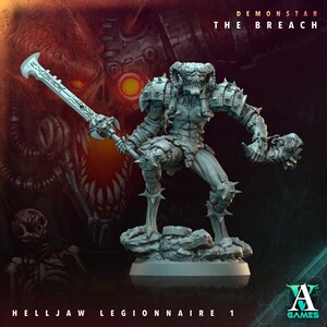 May include: A gray plastic miniature figurine of a demon warrior with horns, holding a sword and a skull. The figurine is standing on a rocky base. The background is a red and orange abstract design with the text "Demonstar The Breach" and "Helljaw Legionnaire 1".
