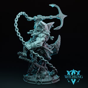 May include: A gray, detailed miniature figurine of a shark-like creature wielding an anchor and chain. The creature has a muscular build and a fierce expression. The base of the figurine is decorated with a rocky surface and seaweed.