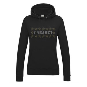 May include: Black hooded sweatshirt with a white rhinestone design that says "CABARET" surrounded by gold stars.