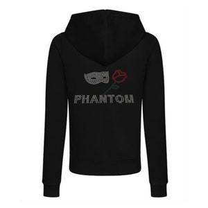 May include: Black zip-up hoodie with a rhinestone design. The design features a mask, a red rose, and the word "PHANTOM" in rhinestones. The hoodie has a hood and long sleeves.