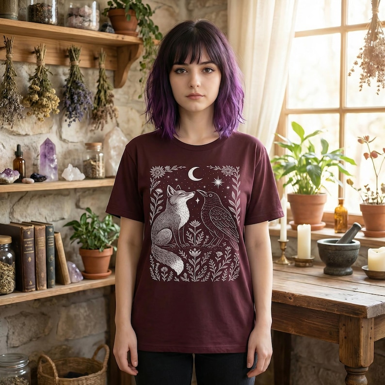 Celestial t-shirt for fans of goblincore and wiccan pagan themes, featuring mystical fox and crow floral design. Witchcore clothing.