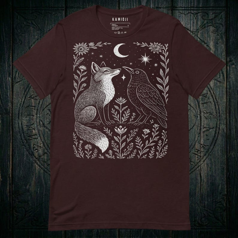 Linocut folk art design, fox and crow under a celestial crescent moon. Oxblood black color variation.