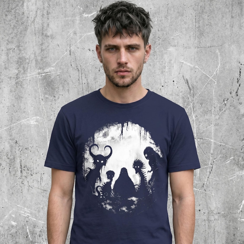 Male wearing a Cryptid horror t-shirt, unisex fit with a crew neck collar, 100% cotton. Navy color variation.