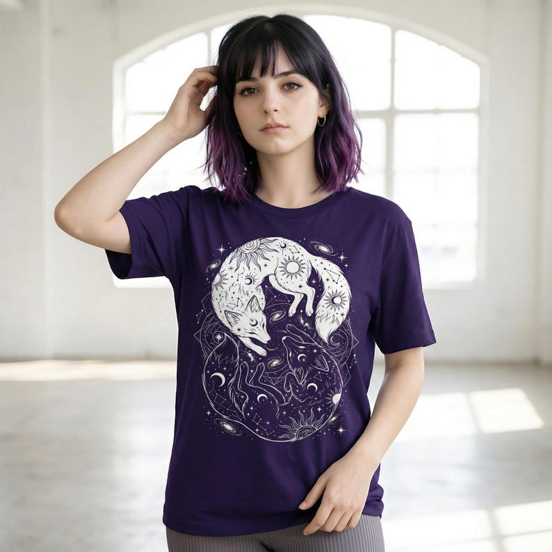 Model wearing purple t-shirt - witchy yin yang fox design with celestial Sun and Moon motifs.