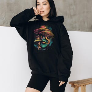 Psychedelic mushroom hoodie with retro vintage and space-inspired design. A KAMIOJI trippy pullover perfect for alt clothing, stoner gifts, and hippie boho styles. Great for y2k sweater fans in womens and mens.