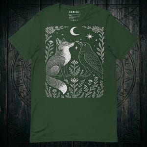 Women's crow shirt with a dark academia aesthetic and detailed gothic illustration. Forest green color variation.