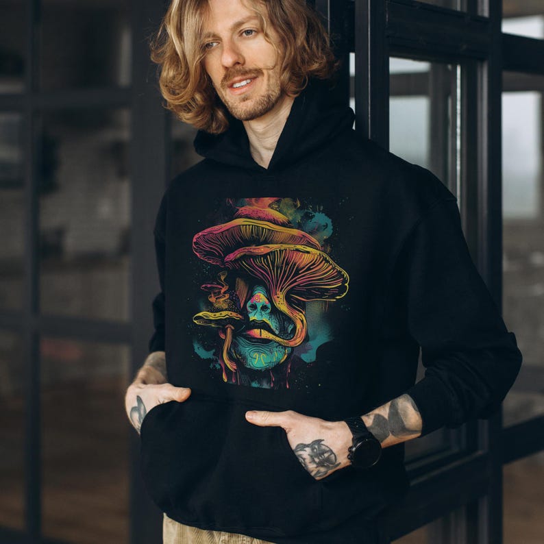 Magic mushroom hoodie blending trippy sweatshirt and psychedelic vibes. A KAMIOJI graphic pullover perfect for stoner gifts, retro vintage, and alt clothing. Ideal for hippie boho and y2k sweater lovers in mens and womens styles.