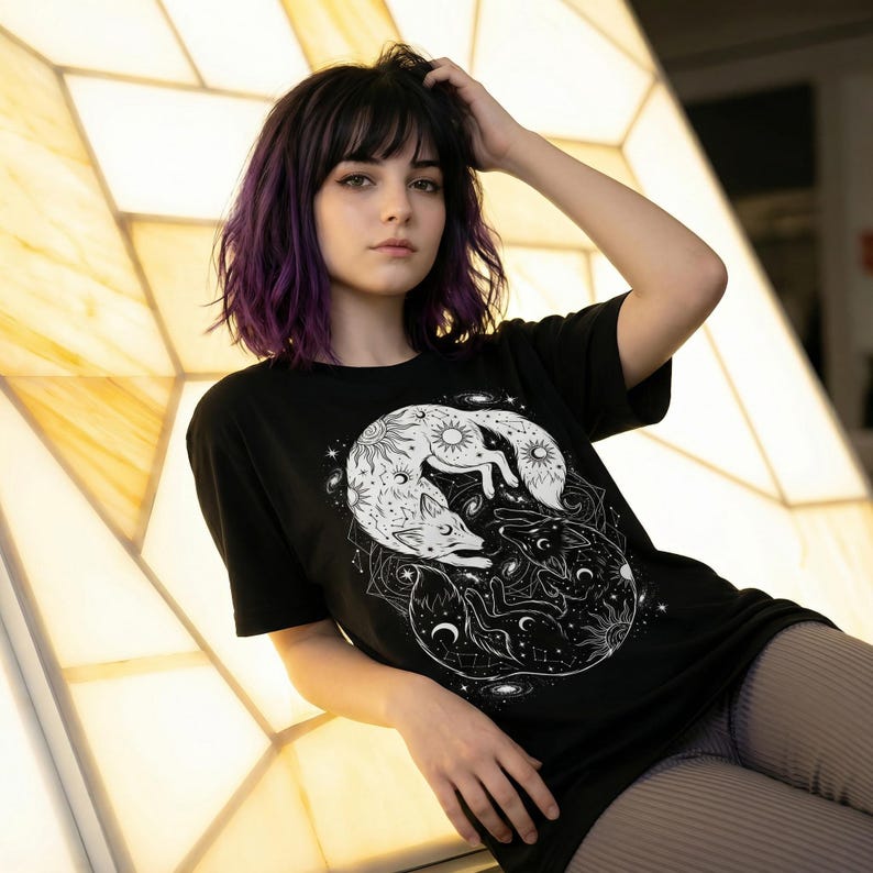 Black cotton tshirt featuring a white and black fox with celestial symbols. Witchy alternative clothing.