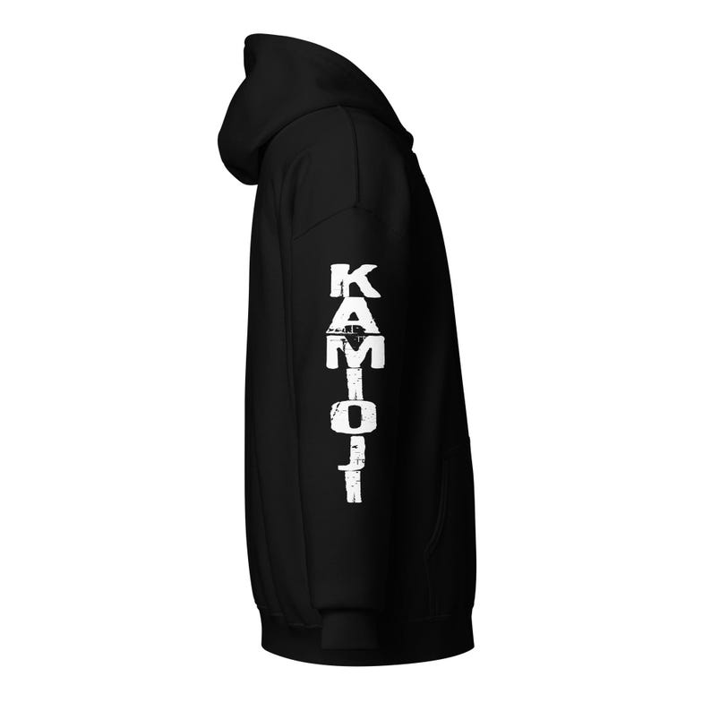 Sleeve print, KAMIOJI logo. Gothic Bigfoot hoodie featuring lofi horror and weird creepy design. A KAMIOJI zip-up hoodie blending Mothman Sasquatch, dark art oddities, and aesthetic vibes. Perfect for gifts and alt clothing fans.