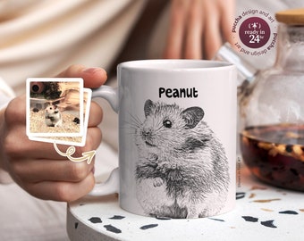 May include: White ceramic mug with a black and white illustration of a hamster. The hamster is looking to the left and has the name "Peanut" printed above it.