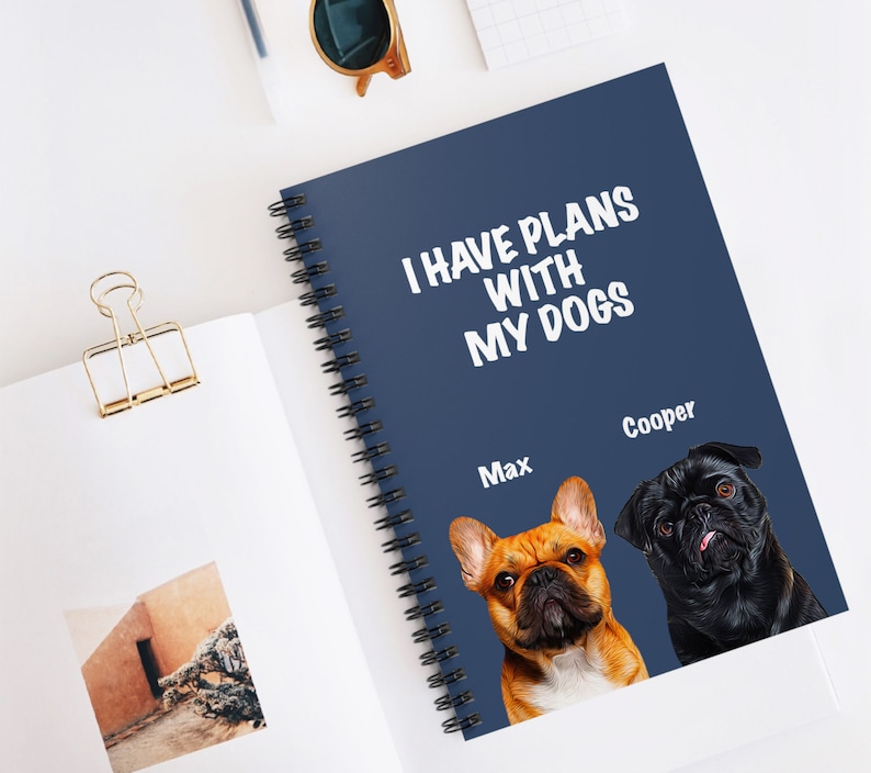 May include: A blue spiral notebook with the text "I have plans with my dogs" in white. The notebook features two dog photos, one of a French Bulldog named Max and one of a Pug named Cooper.