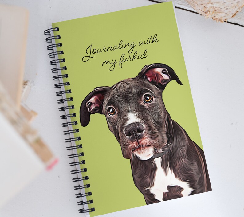 May include: A green spiral bound journal with the text "Journaling with my furkid" printed on the front cover. A black and white dog with a white patch on its chest is pictured on the cover.