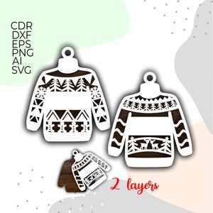 Puede incluir: Adornos navideños blancos cortados con láser con intrincados diseños, incluyendo árboles y patrones geométricos. La imagen muestra tres adornos, uno parcialmente ensamblado, con el texto "2 layers" y opciones de tipo de archivo.