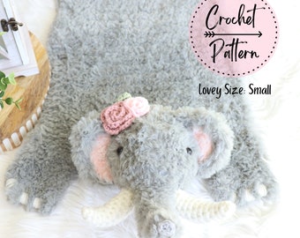 May include: A gray crocheted elephant lovey with pink ears and a pink flower crown. The lovey is on a white fluffy surface. The text "Crochet Pattern" is in a pink circle with a dotted border. The text "Lovey Size: Small" is below the circle.