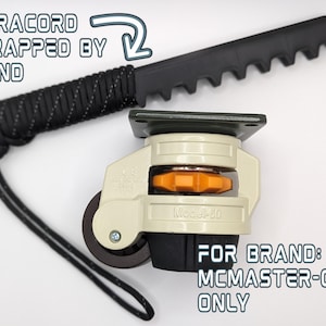 May include: A black and green swivel caster with a black paracord handle. The caster is labeled "Model 360" and is for the McMaster-Carr brand.