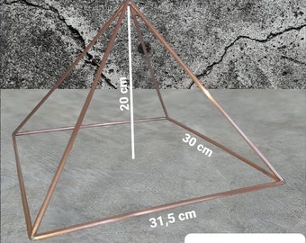 May include: A copper-colored pyramid with a square base. The pyramid is 20 inches tall, 30 inches wide, and 31.5 inches long. The pyramid is made of metal and has a shiny finish. @fibiyoenerji