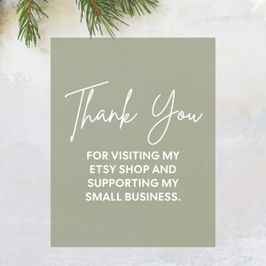 May include: A sage green card with the words "Thank You" in elegant white script. Below, the text reads "For visiting my Etsy shop and supporting my small business." Festive greenery and ornaments frame the card.