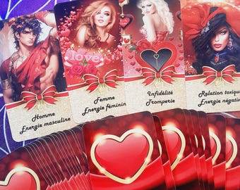 May include: A set of oracle cards with red hearts and gold accents. The cards feature illustrations of people and text in French. The text on the cards includes "Homme Energie Masculine", "Femme Energie Feminie", "Infidelite Tromperie", and "Relation Toxique Energie Negative".