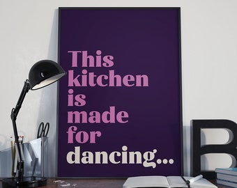 May include: A purple poster with white text that reads "This kitchen is made for dancing..." in a bold, retro font.
