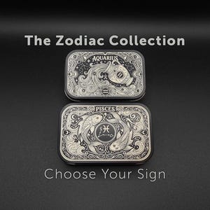 May include: Two rectangular black metal tins featuring intricate white line art designs. The top tin displays the Aquarius zodiac sign with a water bearer, while the bottom tin shows the Pisces sign with two fish. Text reads The Zodiac Collection and Choose Your Sign.