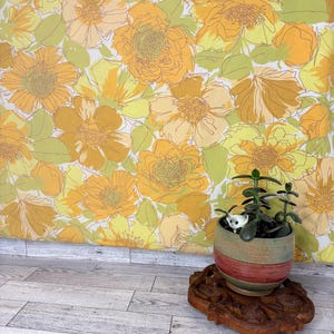 May include: A vintage floral wallpaper in shades of yellow, orange, and green. A small potted plant with a ceramic pot and a wooden stand is in the foreground. The wallpaper features large, stylized flower patterns.