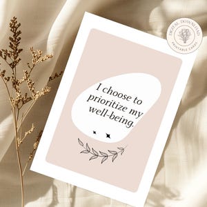 May include: A printable card with a pink background and black text that reads "I choose to prioritize my well-being." The card features a simple black floral design.