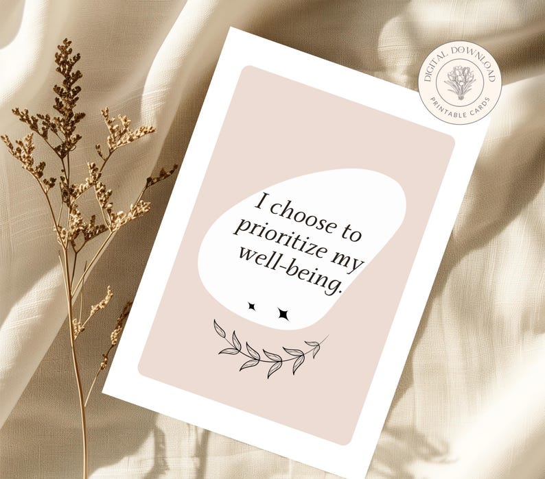 May include: A printable card with a pink background and black text that reads "I choose to prioritize my well-being." The card features a simple black floral design.