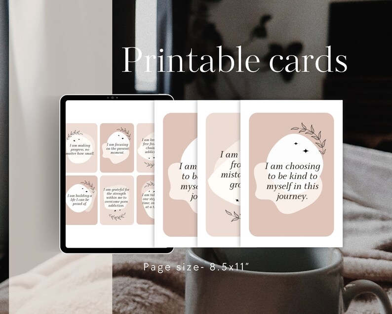 May include: Printable cards with positive affirmations on a pink background. The cards feature a simple design with black text and a small floral illustration. The text on the cards includes phrases like "I am making progress, no matter how small" and "I am choosing to be kind to myself on this journey."
