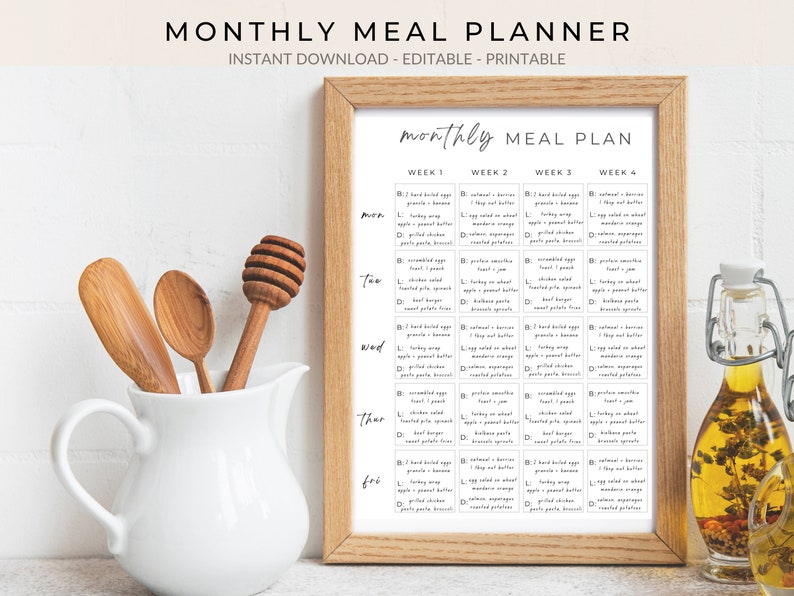May include: A printable monthly meal planner with a brown wooden frame. The planner is divided into four weeks and includes a list of meals for each day of the week. The text on the planner reads "monthly MEAL PLAN".
