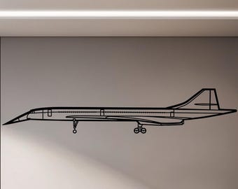 May include: A black outline of a Concorde supersonic jetliner is mounted on a wall. The artwork is a minimalist design, showcasing the plane's distinctive shape. The image is set in an office environment, with a desk, chair, and computer visible.