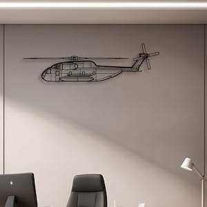 May include: A black metal helicopter wall art piece. The artwork is a line drawing of a helicopter, mounted on a light grey wall. The helicopter's details, including the rotors and body, are clearly defined. The piece is displayed in an office setting.