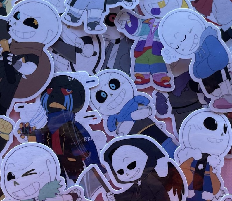 May include: A collection of die-cut vinyl stickers featuring various cartoon skeleton characters in different outfits and poses. The characters include figures with blue scarves, dark hoods, colourful jackets, and one with the word ERROR printed on clothing.