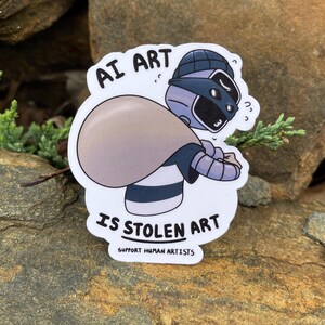 A sticker of a robot holding a bag over his shoulder.