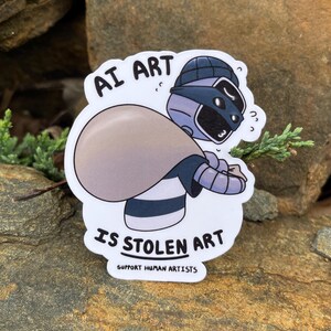 A sticker of a robot holding a bag over his shoulder.